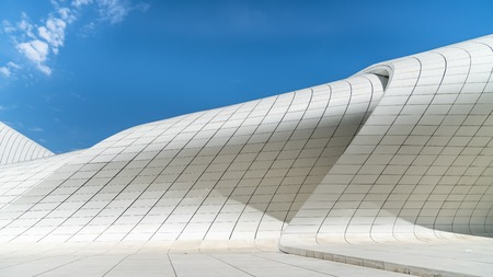 Baku, Azerbaijan - April 2018: Building exterior of Haydar Aliyev Centre which was designed by Zaha Hadid and is noted for its curvy, flowing architecture that avoids straight lines and sharp angles.のeditorial素材