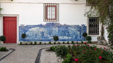 Lisbon, Portugal - April 2018: Typical mural with fighting scene, made of blue tiles, at Alfamo districtのeditorial素材