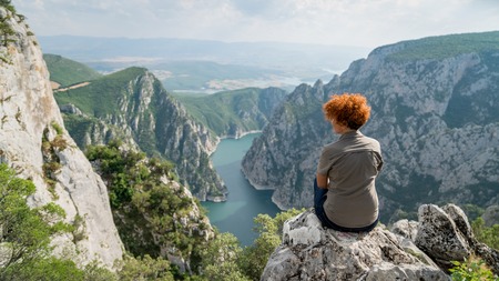 Woman overlooking Sahinkaya Canyon in Vezirkopru district of Samsun with Kizilirmak river and lake,Turkey.のeditorial素材