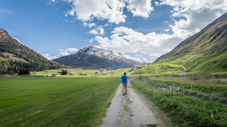 Norway - May 2017: Man walking towards a scenic landscape in Norwayのeditorial素材