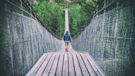 Switzerland, May 2017: Man walking down in Goms Hanging Bridge in Switzerlandのeditorial素材