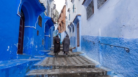 Chefchaouen , Morocco - April 2018: Unidentified men walking in blue medina of Chefchaouen city in Morocco, North Africaのeditorial素材