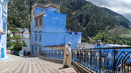 Chefchaouen , Morocco - April 2018: Unidentified man walking in blue medina of Chefchaouen city in Morocco, North Africaのeditorial素材