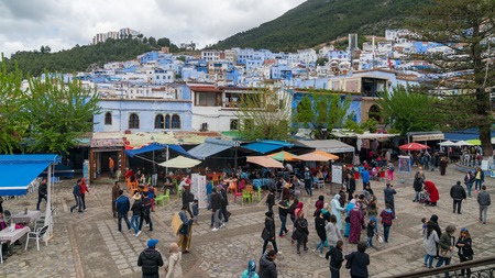 Chefchaouen, Morocco - April 2018: Chefchaouen medina center with unidentified people, blue city skyline on the hill, Moroccoのeditorial素材