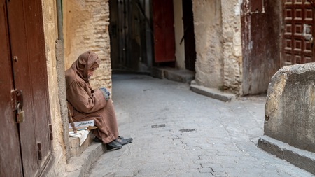 Fez, Morocco - April 2018: Anonymous poor beggar in the street of Fez, Morocco.のeditorial素材