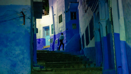 Chefchaouen , Morocco - April 2018: Unidentified man in blue medina of Chefchaouen city at night in Morocco, North Africaのeditorial素材