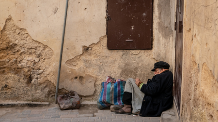 Fez, Morocco - April 2018: Anonymous poor beggar in the street of Fez, Morocco.のeditorial素材
