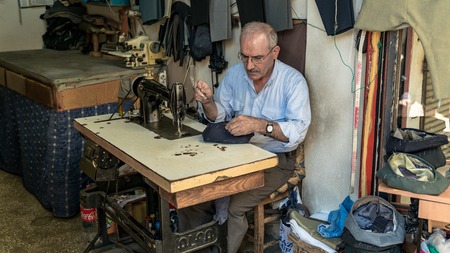 Adiyaman, Turkey - July 2018: Tailor working on traditional handycrafts in the Adiyaman city historical old Oturakci bazaar inside the old city, Turkeyのeditorial素材