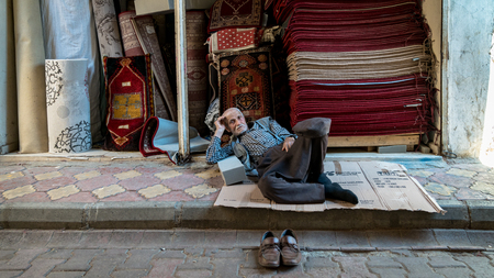 Adiyaman, Turkey - July 2018: Unidentified old man resting in Adiyaman city historical old Oturakci bazaar inside the old city, Turkeyのeditorial素材