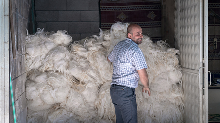 Adiyaman, Turkey - July 2018: Unidentified man selling wool in his shop in Adiyaman city historical old Oturakci bazaar inside the old cityのeditorial素材