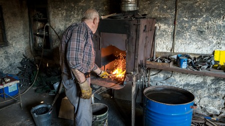 Adiyaman, Turkey - July 2018: Tailor working on traditional handycrafts in the Adiyaman city historical old Oturakci bazaar inside the old city, Turkeyのeditorial素材