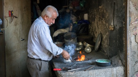 Adiyaman, Turkey - July 2018: Tailor working on traditional handycrafts in the Adiyaman city historical old Oturakci bazaar inside the old city, Turkeyのeditorial素材