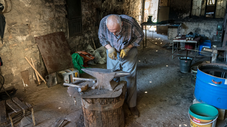 Adiyaman, Turkey - July 2018: Tailor working on traditional handycrafts in the Adiyaman city historical old Oturakci bazaar inside the old city, Turkeyのeditorial素材