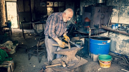 Adiyaman, Turkey - July 2018: Tailor working on traditional handycrafts in the Adiyaman city historical old Oturakci bazaar inside the old city, Turkeyのeditorial素材