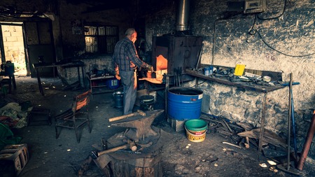 Adiyaman, Turkey - July 2018: Tailor working on traditional handycrafts in the Adiyaman city historical old Oturakci bazaar inside the old city, Turkeyのeditorial素材