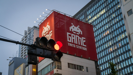 Tokyo, Japan - August 2018: Akihabara Electric Town district in the evening with red light and Taito arcade gaming buildingのeditorial素材