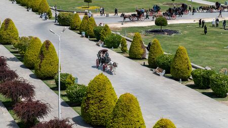 Isfahan, Iran - May 2019: Tourists having a horse carriage ride around Isfahan Naqsh-e Jahan Square also called Imam Squareのeditorial素材