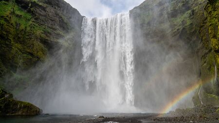 Huge waterfall of Skogafoss with a rainbow formed from sun shine in Skogar, south of Icelandの写真素材