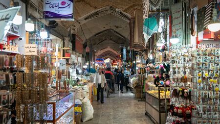 Isfihan, Iran - May 2019: Tourists and local people shopping in Bazar Bozorg, also known as the...