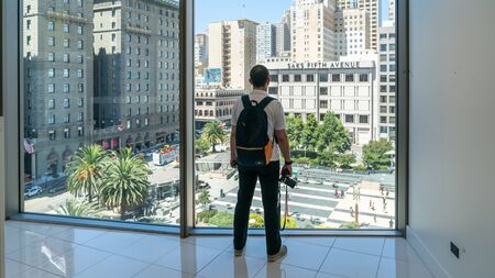 San Francisco, USA - August 2019: Unidentified man looking at Union Square behind windowsのeditorial素材