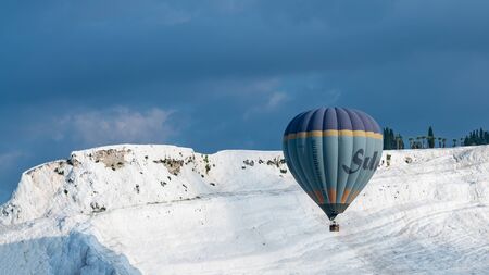 Denizli, Turkey - October 2019: Hot air balloon flying over spectacular Pamukkale travertineのeditorial素材