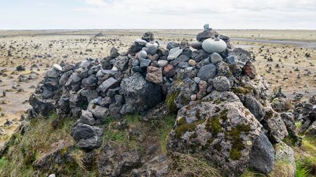 Cairns made of stones on a lava field called Laufskalavarda in southern Icelandの写真素材