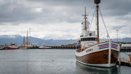 Husavik, Iceland - June 2019: Traditional old wooden fisherman boats used for whale watching in...