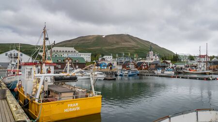 Husavik, Iceland - June 2019: Traditional old wooden fisherman boats used for whale watching in...