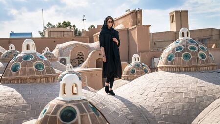 Kashan, Iran - May 2019: Iranian woman on the brick dome roof of Sultan Amir Ahmad Qasemi Bath houseのeditorial素材