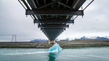 A big melting ice block floating towards the ocean in Jokulsarlon glacier lagoon, Iceland. Global warming and climate change conceptの写真素材