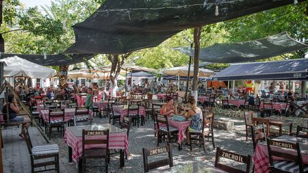 Foca, Izmir, Turkey - August 2013: People drinking tea in a tea cafe of resort town of Foca izmirのeditorial素材