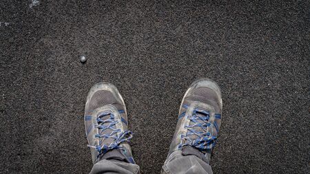 Shoes on volcanic black sand formation from black sand beach, Icelandの写真素材