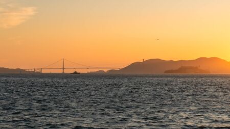 San Francisco, USA - August 2019: Golden Gate Bridge from a distance during sunsetの写真素材