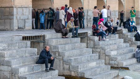 Isfahan, Iran - May 2019: Khaju bridge over Zayandeh river with tourists and local people sitting and walking aroundのeditorial素材
