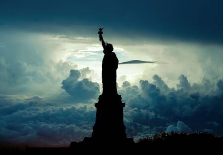 New York, USA - November 2012: Silhouette of Statue of Liberty over dramatic skiesのeditorial素材
