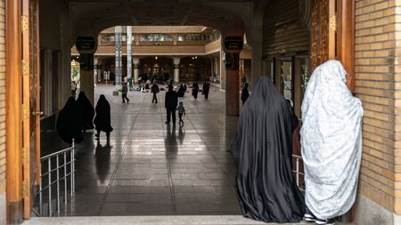 Shrine of Fatima Masumeh, Qom, Iran - May 2019: Iranian women at the gates of Shrine of Fatima Masumeh in Qom, which is considered by Shia Muslims to be the second most sacred city in Iran.のeditorial素材