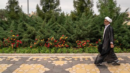 Qom, Iran - May 2019: Iranian man walking a street in Qom, which is considered by Shia Muslims to be the second most sacred city in Iran.のeditorial素材