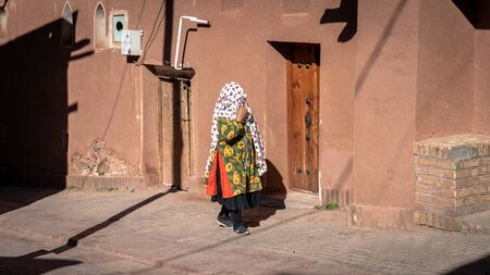 Abyaneh, Iran - May 2019: Unidentified woman with traditional Persian clothes walking in Abyahenのeditorial素材