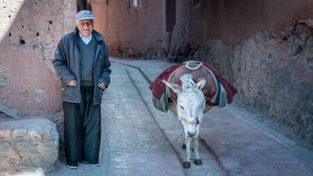 Abyaneh, Iran - May 2019: Old man and his donkey in the traditional village of Abyanehのeditorial素材