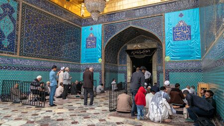 Shrine of Fatima Masumeh, Qom, Iran - May 2019: Iranian men praying inside Shrine of Fatima Masumeh in Qom, which is considered by Shia Muslims to be the second most sacred city in Iran.のeditorial素材