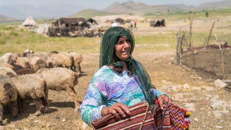 Shiraz, Iran - May 2019: Qashqai nomadic woman selling handicraft materials. The Qasqhai are nomadic people living in temporary villages.のeditorial素材