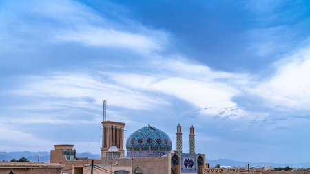 Yazd, Iran - May 2019: Yazd cityscape with a badgir, wind catching tower during sunset