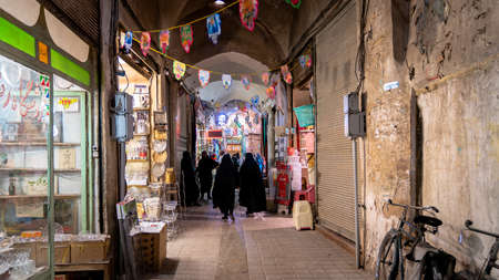 Isfahan, Iran - May 2019: Grand bazaar of Qashan with tourists and local people shopping, historical marketのeditorial素材