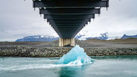 A big melting ice block floating towards the ocean in Jokulsarlon glacier lagoon, Iceland. Global warming and climate change conceptの写真素材