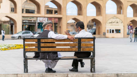 Yazd, Iran - May 2019: Iranian men sitting at a benchのeditorial素材