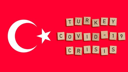 Turkey Covid 19 crisis written with wooden tiles over Turkish flag background. Respiratory syndrome coronavirus and Novel coronavirus 2019-nCoV. Virus Pandemic Turkish Conceptの写真素材