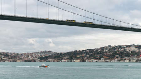 Istanbul, Turkey - October 2018: Coast guard boat in bosphorus strait sailing under 15 July Martyrs Bridgeのeditorial素材