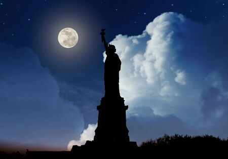Silhouette of Statue of Liberty over dramatic full moonの写真素材