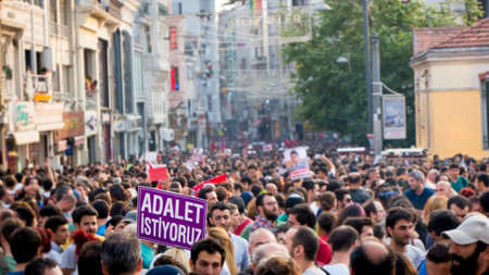 Istanbul, Turkey - June 2013: Turkish people protesting government in Taksim square. Sign says we want justice in Turkish.のeditorial素材