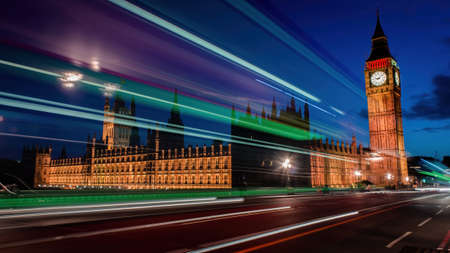 London, UK - August 2018: Long exposure photo of Westminster House of Parliament of UK and Big Ben at night. The lights by a bus done intentionally long exposureの写真素材
